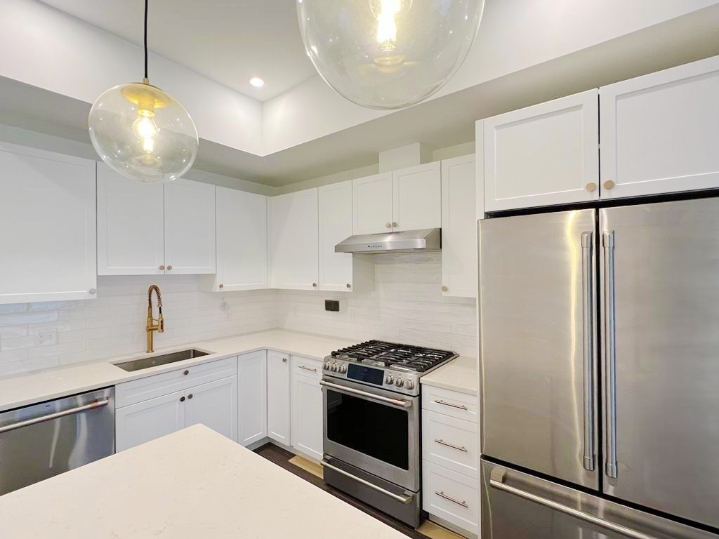 23 Charles Park Road, Unit 23 Boston, MA 02132 - Photo 6 of 35 a kitchen with stainless steel appliances a stove a sink and a refrigerator
