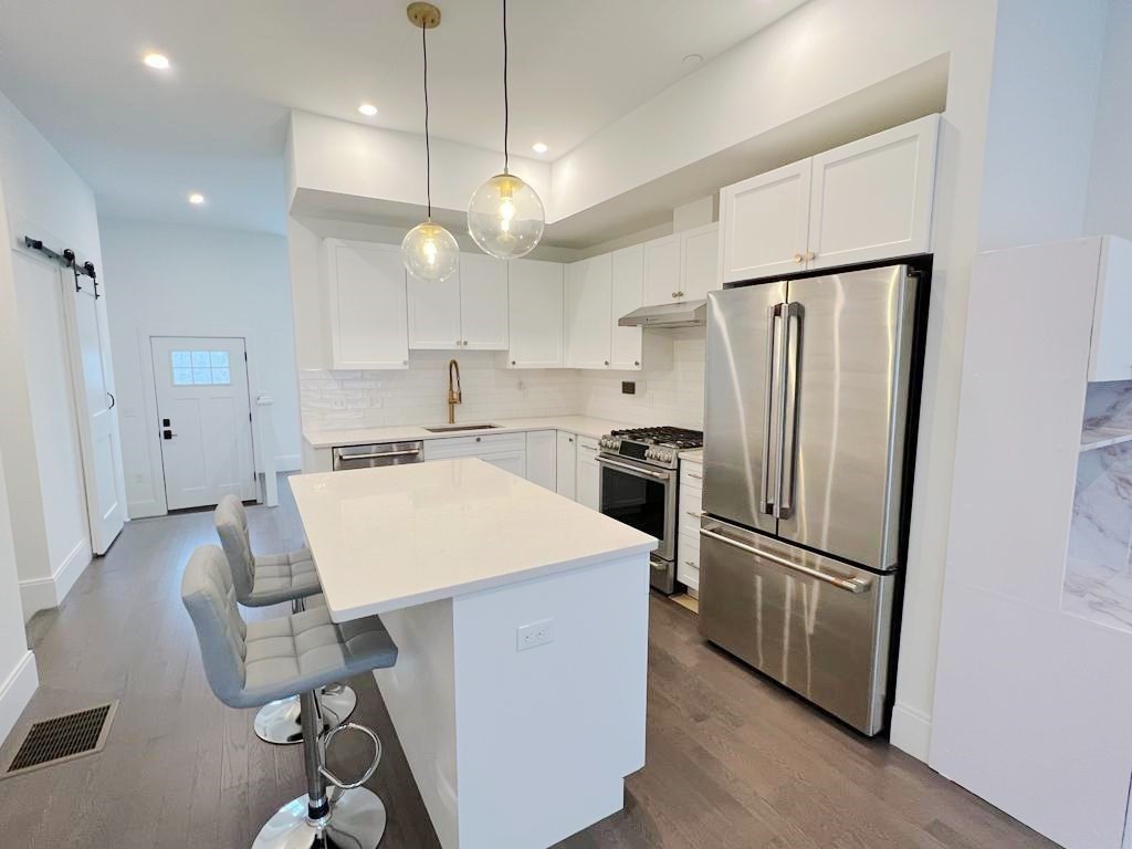 23 Charles Park Road, Unit 23 Boston, MA 02132 - Photo 7 of 35 a kitchen with refrigerator and cabinets