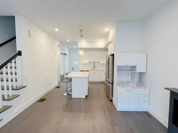a kitchen with a sink appliances and cabinets