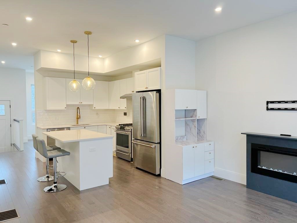 23 Charles Park Road, Unit 23 Boston, MA 02132 - Photo 10 of 35 a kitchen with a refrigerator a sink and a stove top oven
