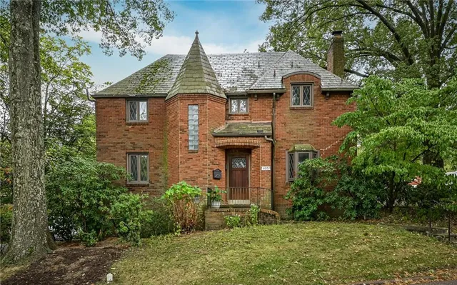 a front view of a house with a yard