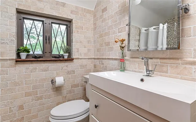 a bathroom with a sink a toilet and tub