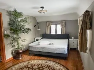 a spacious bedroom with a bed next to a window