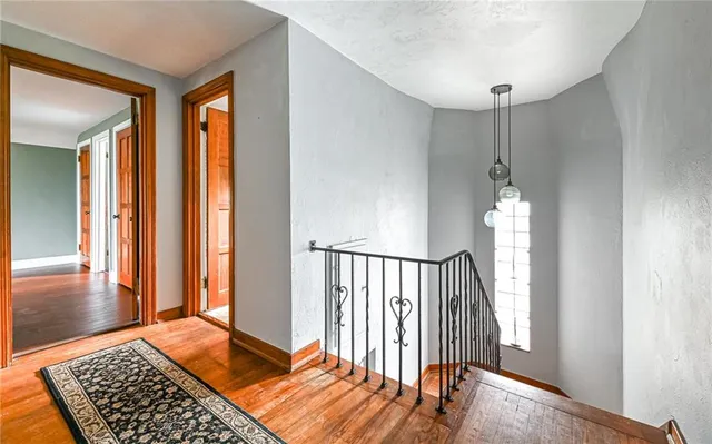 a view of a room with wooden floor and a window