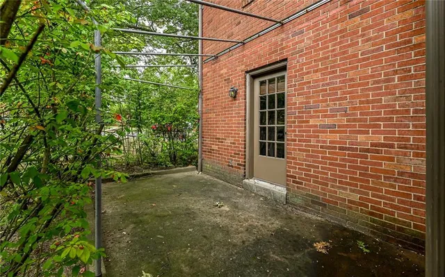 a view of a brick house with a tree