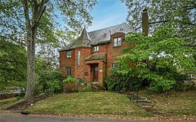 front view of a house with a tree