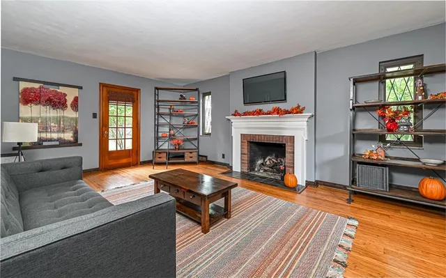 a living room with fireplace furniture and a flat screen tv
