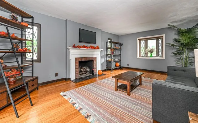 a living room with furniture a flat screen tv and a fireplace