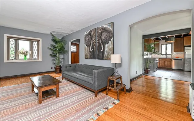 a living room with furniture and a wooden floor