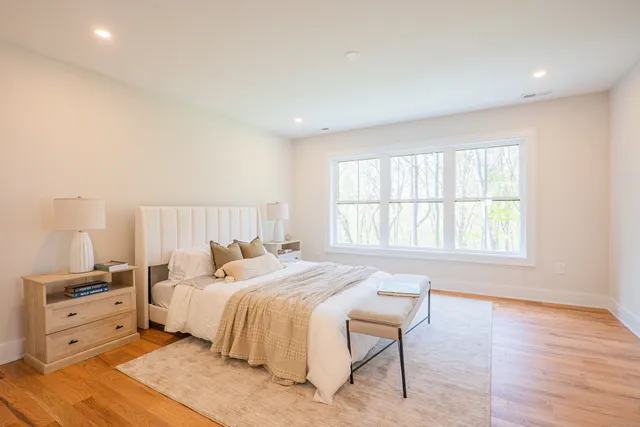 a bedroom with a bed and a window