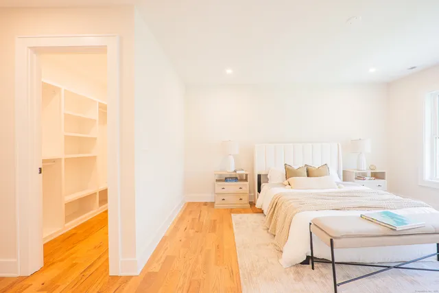 a bedroom with a bed and a night stand