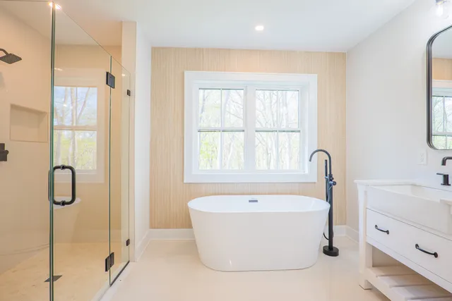 a bathroom with a bathtub and a shower