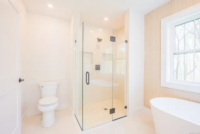 a bathroom with a toilet a sink and a shower