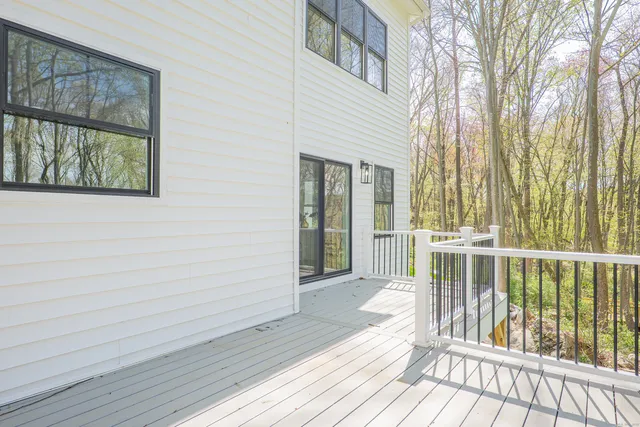 a view of a balcony with wooden floor