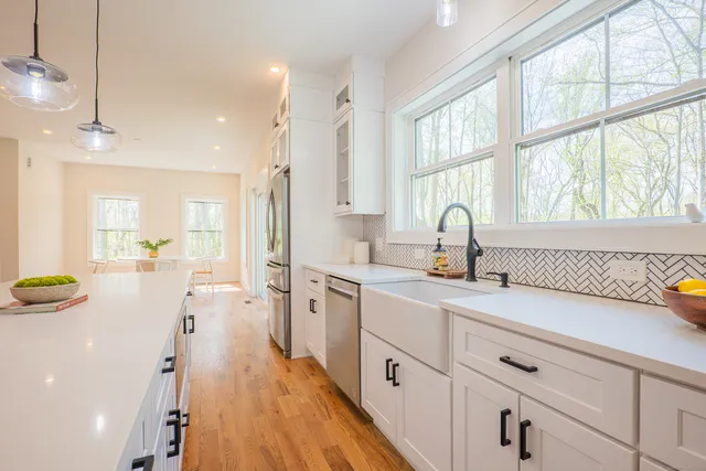 a kitchen with a sink a window and stainless steel appliances