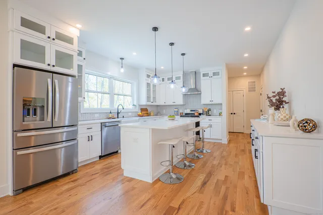 a kitchen with white cabinets and stainless steel appliances