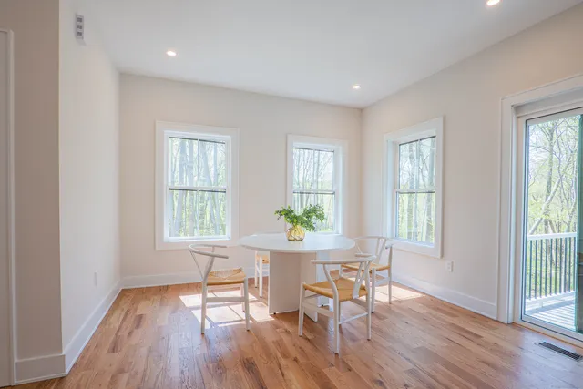 a workspace with wooden floor and a window