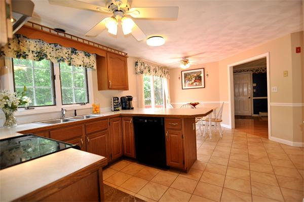 81 R Tenney Road Westford, MA 01886 - Photo 9 of 18 a kitchen with stainless steel appliances granite countertop a sink and a refrigerator