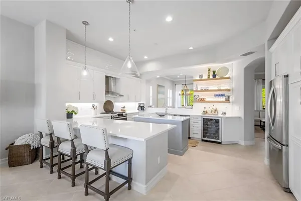a kitchen with a sink and chairs