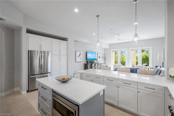a kitchen with stainless steel appliances granite countertop a sink a stove and refrigerator