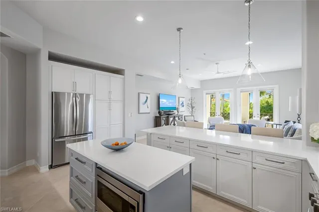 a kitchen with stainless steel appliances granite countertop a sink a stove and refrigerator