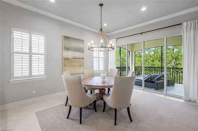 a dining room with furniture window and outside view