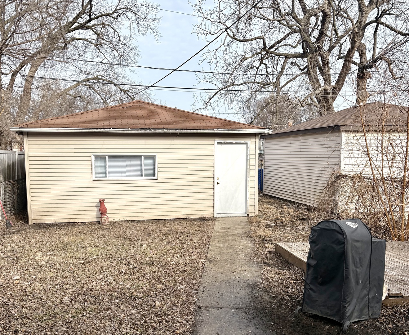 1116 West 111th Place Chicago, IL 60643 - Photo 2 of 3 a backyard of a house with potted plants