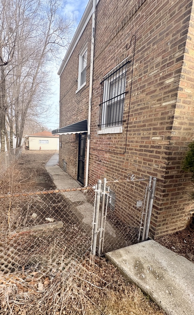 1116 West 111th Place Chicago, IL 60643 - Photo 3 of 3 a brick building with a bench in front of it