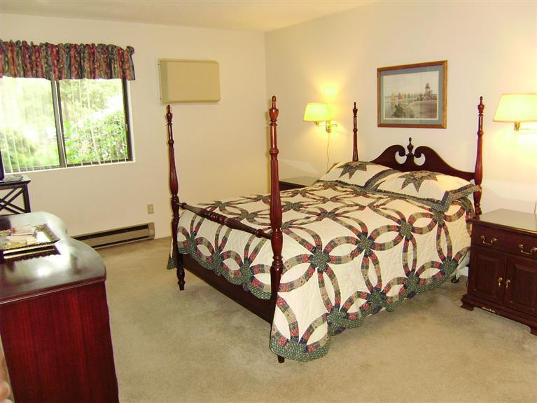 37 Roundhouse Road, Unit 37 Buzzards Bay, MA 02532 - Photo 11 of 12 a spacious bedroom with a bed and a window