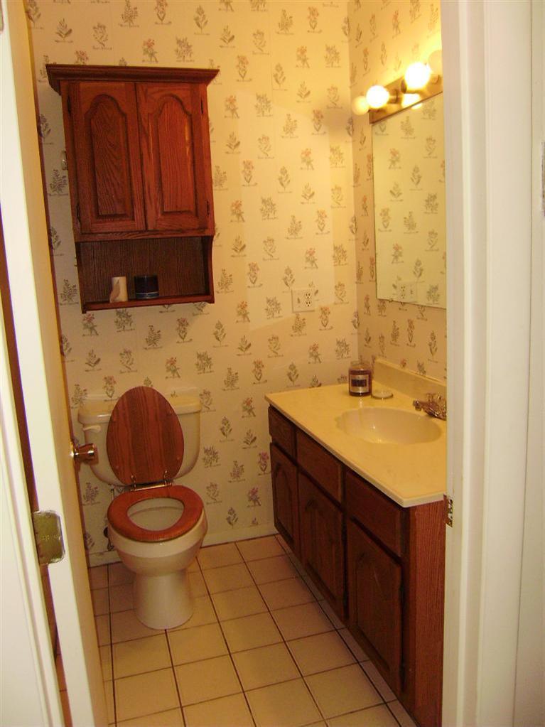 37 Roundhouse Road, Unit 37 Buzzards Bay, MA 02532 - Photo 12 of 12 a bathroom with a granite countertop toilet sink and mirror