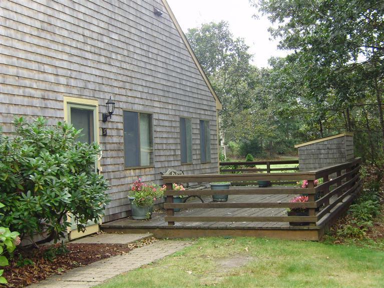 37 Roundhouse Road, Unit 37 Buzzards Bay, MA 02532 - Photo 2 of 12 a front view of a house with a garden