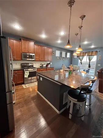 a kitchen with kitchen island a sink stove and refrigerator
