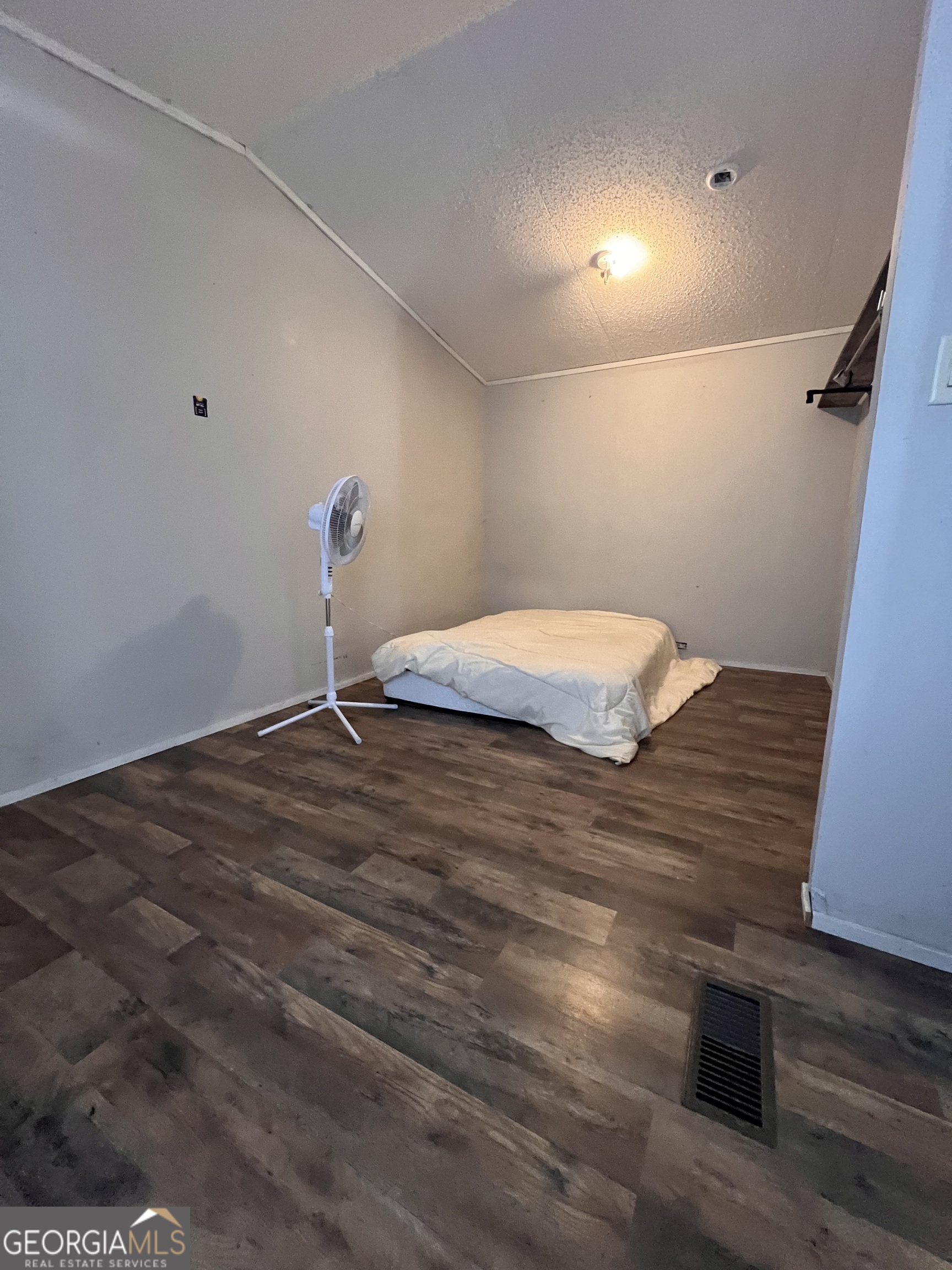 113 Riverview Soperton, GA 30457 - Photo 12 of 16 a bedroom with a bed and wooden floor