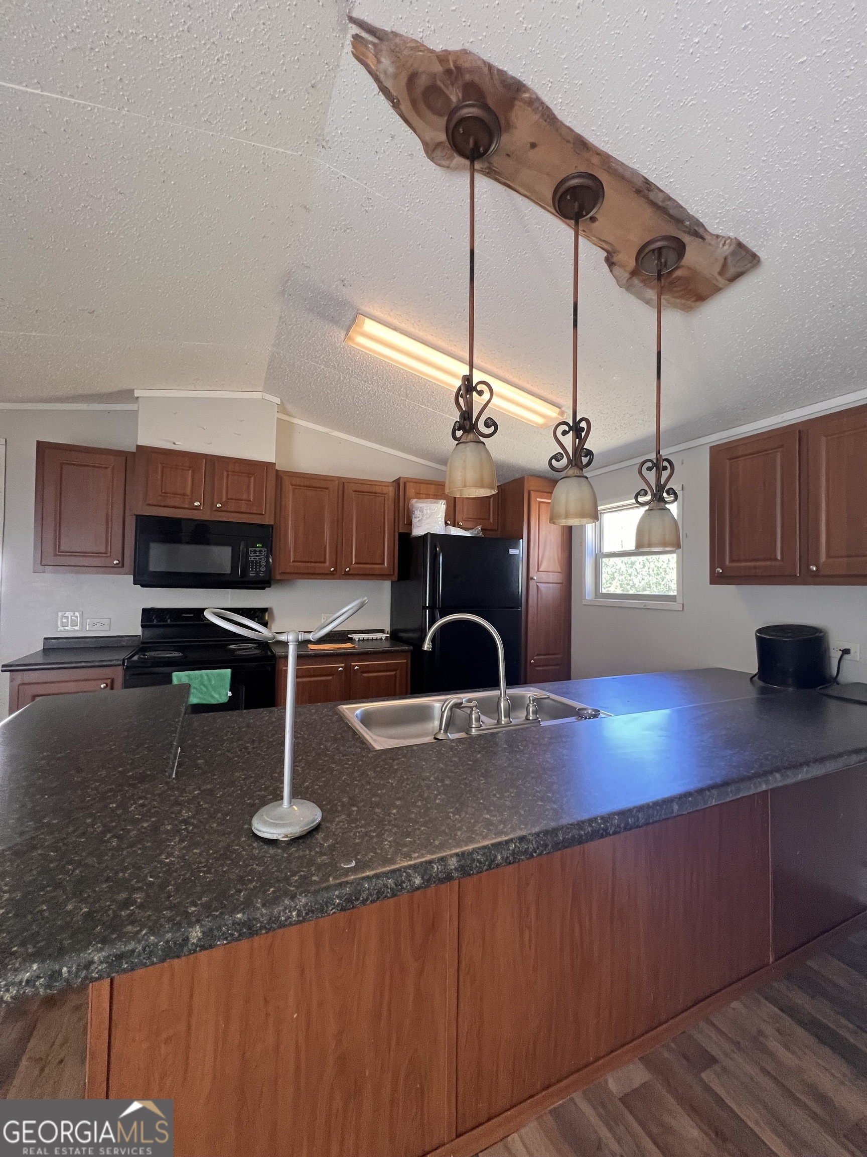 113 Riverview Soperton, GA 30457 - Photo 6 of 16 a kitchen with stainless steel appliances granite countertop a sink a counter space and cabinets