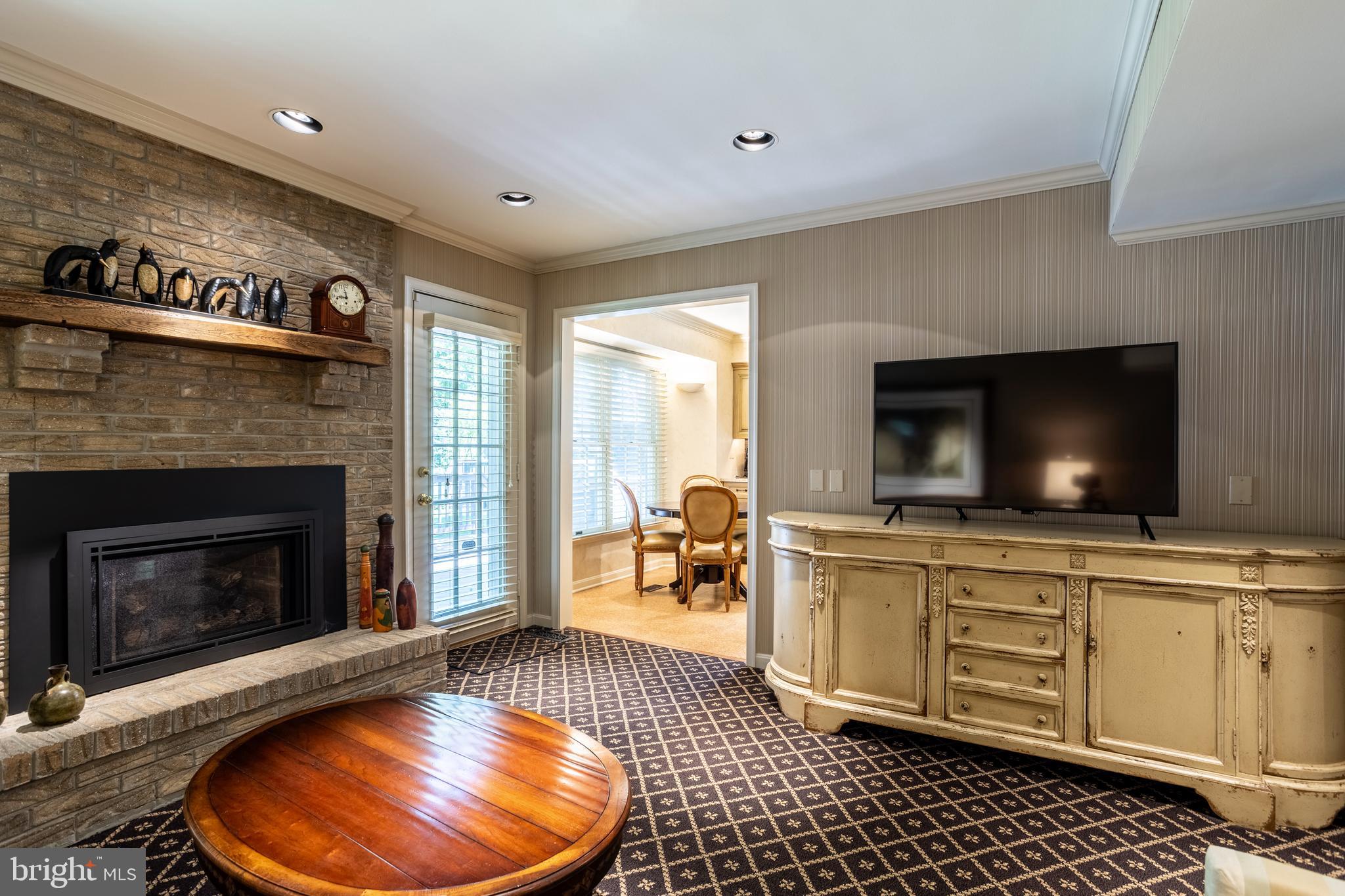 63 Raisin Tree Circle Baltimore, MD 21208 - Photo 21 of 57 a living room with furniture a flat screen tv and a fireplace