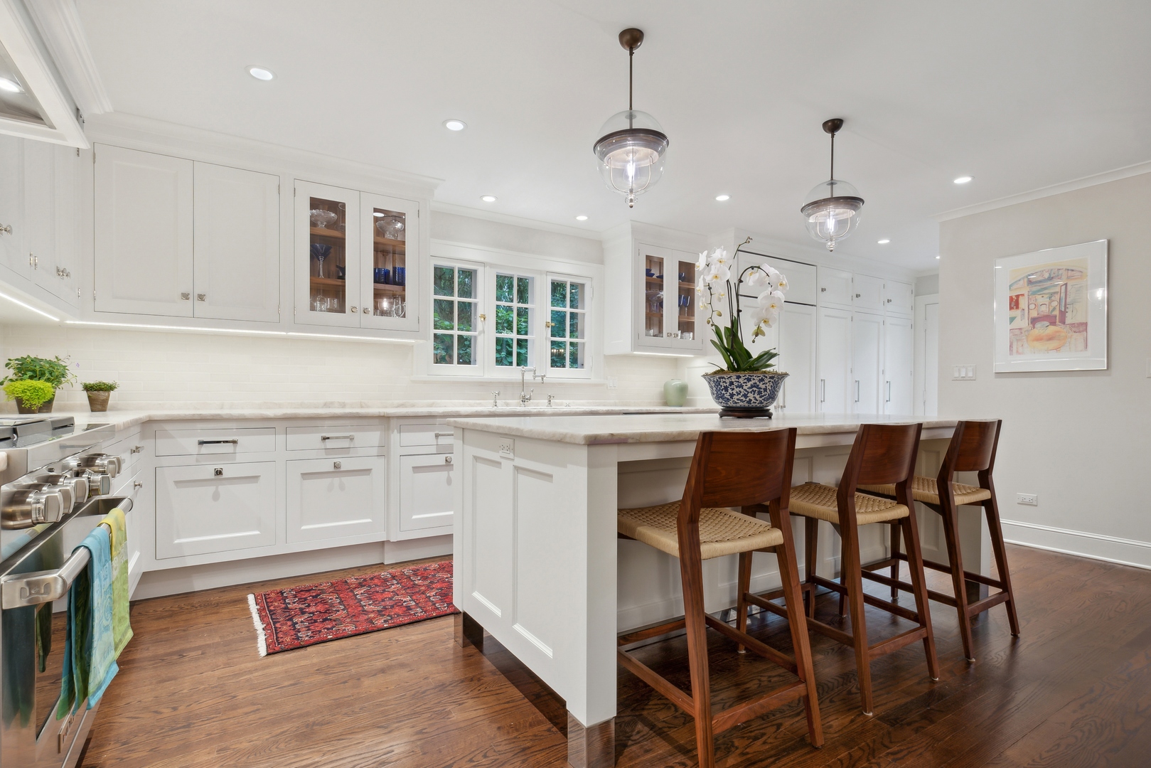 460 Washington Road Lake Forest, IL 60045 - Photo 13 of 50 a kitchen with kitchen island granite countertop a table chairs sink and cabinets