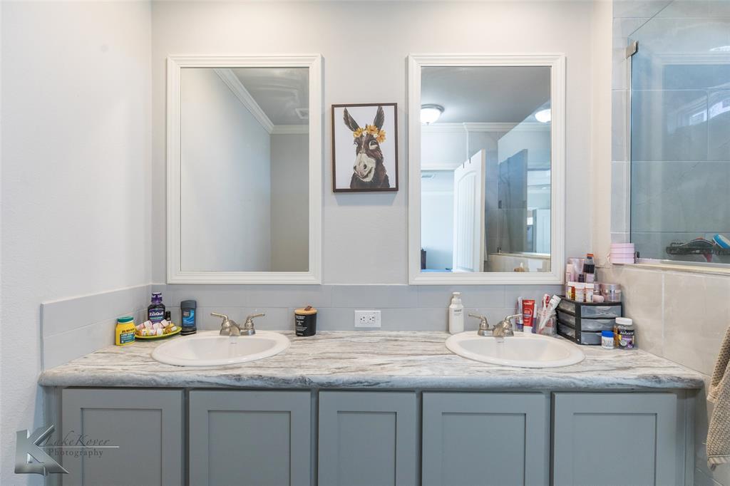 11682 County Road 434 Merkel, TX 79536 - Photo 13 of 37 a bathroom with a granite countertop sink and a mirror