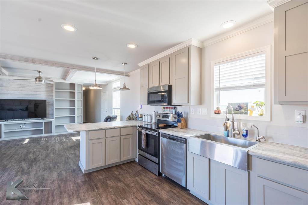 11682 County Road 434 Merkel, TX 79536 - Photo 20 of 37 a kitchen with a sink stove cabinets and refrigerator