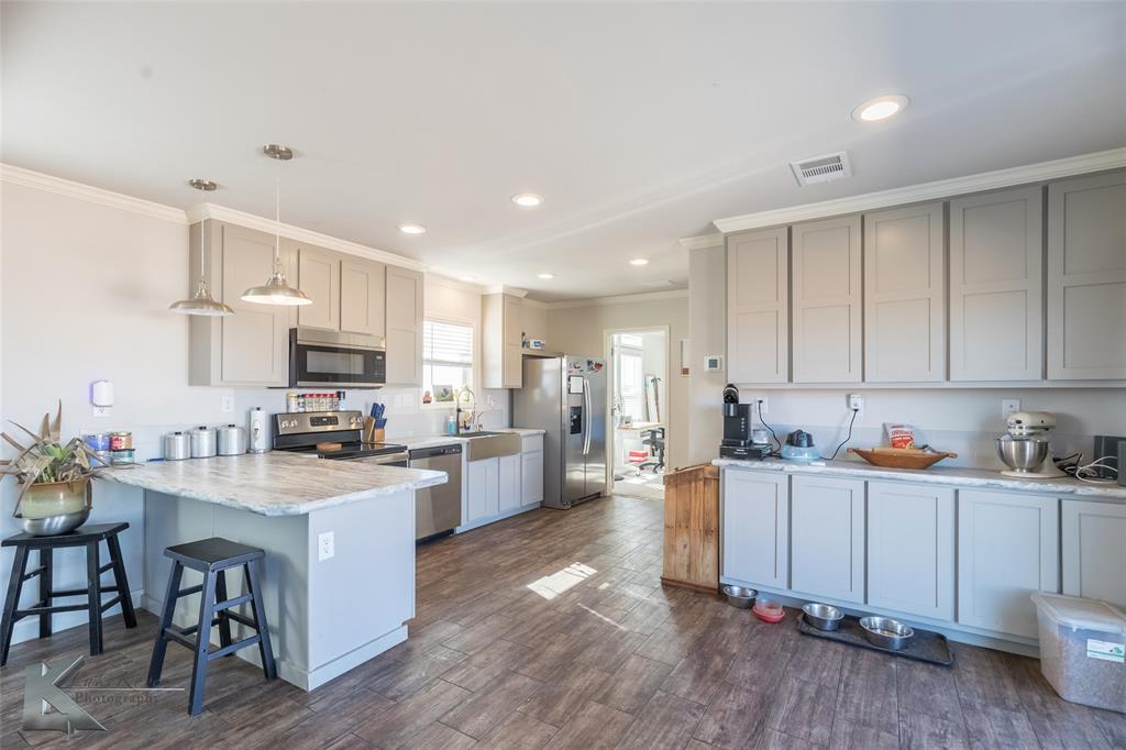 11682 County Road 434 Merkel, TX 79536 - Photo 22 of 37 a kitchen with stainless steel appliances a stove a sink a refrigerator and cabinets