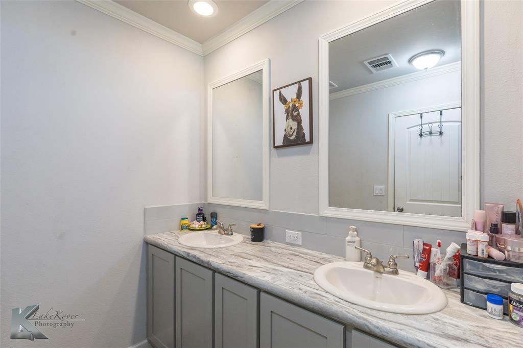 11682 County Road 434 Merkel, TX 79536 - Photo 10 of 37 a bathroom with a granite countertop sink and a mirror
