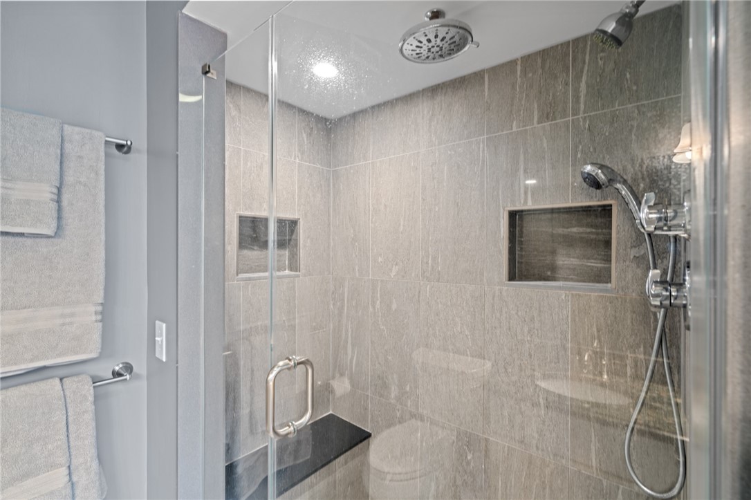 31 Sharon Drive Coventry, RI 02816 - Photo 29 of 49 Custom tiled shower with bench seat and multiple shower heads.