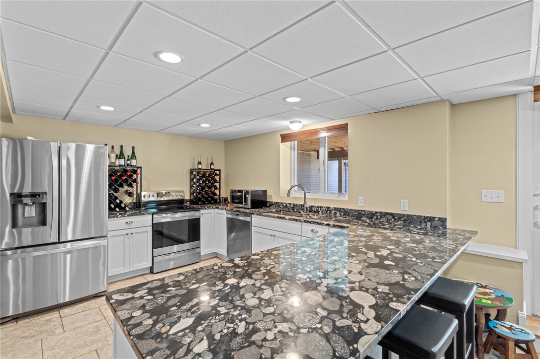 31 Sharon Drive Coventry, RI 02816 - Photo 36 of 49 Lover level kitchen with granite countertops and stainless appliances.