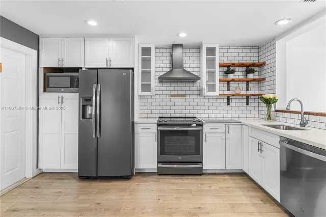 a kitchen with stainless steel appliances a refrigerator and a sink