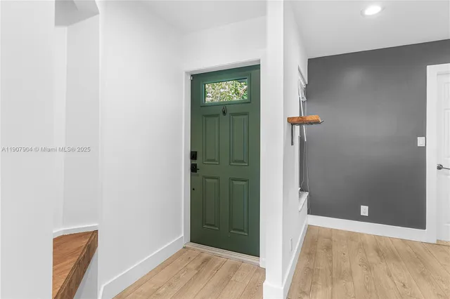 an empty room with closet and wooden floor