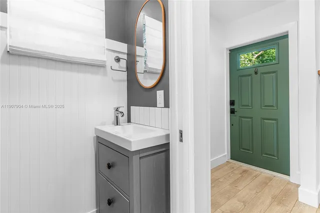 a bathroom with a sink a mirror and a shower