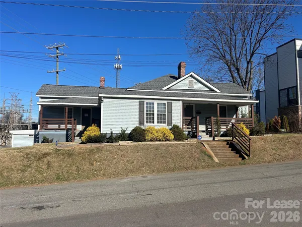 a view of a house with a porch and sitting area