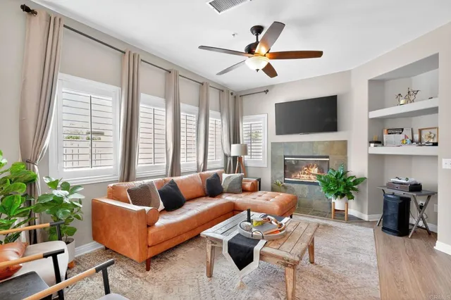 a living room with furniture a fireplace and a flat screen tv