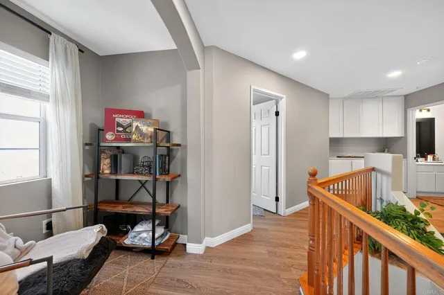 a view of a hallway with workspace and wooden floor