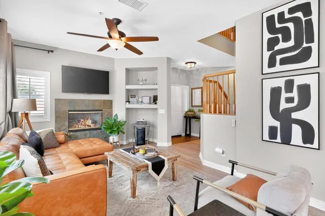 a living room with fireplace furniture and a flat screen tv