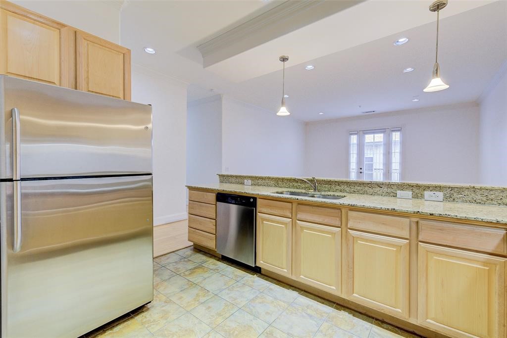 7134 Mapleridge Street, Unit 3B Houston, TX 77081 - Photo 11 of 26 a kitchen with stainless steel appliances granite countertop a refrigerator a stove and a sink
